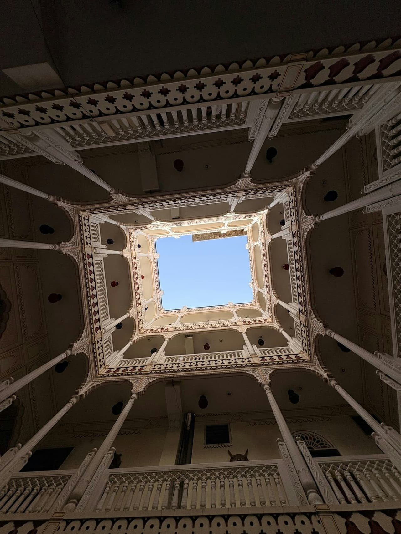 Looking up through a courtyard of carved balconies