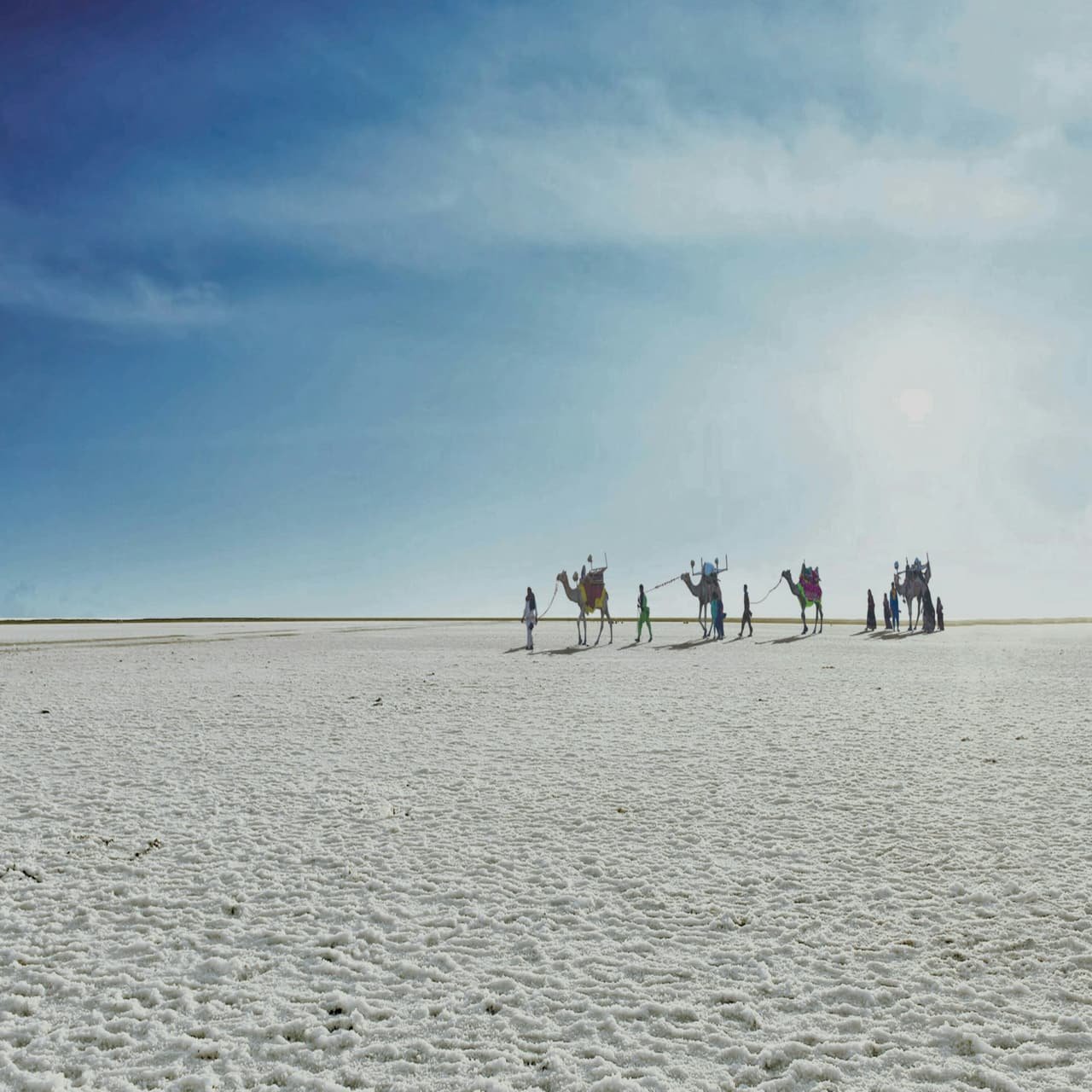 Visitors walking far out on the White Rann at dawn
