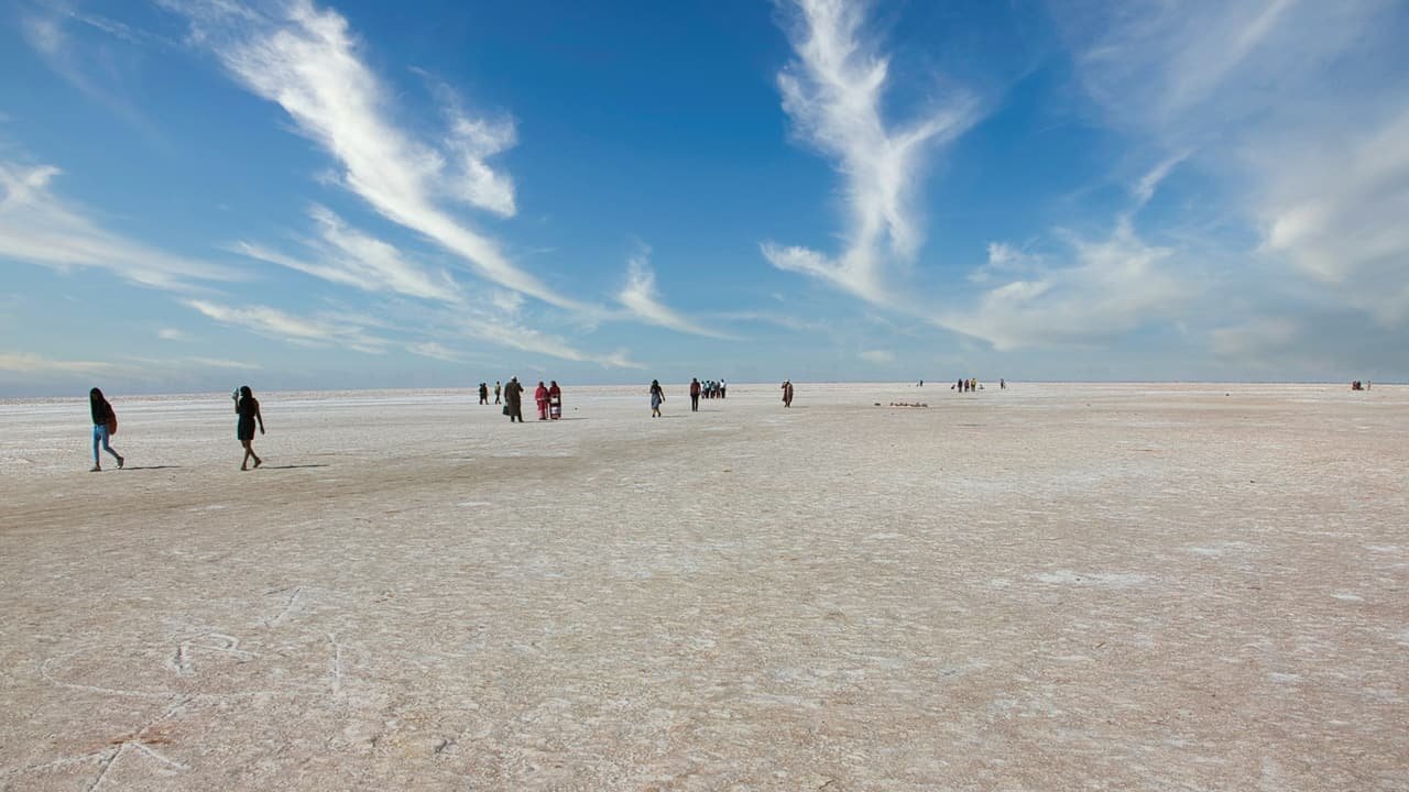 Families walking out onto the salt under a wide sky