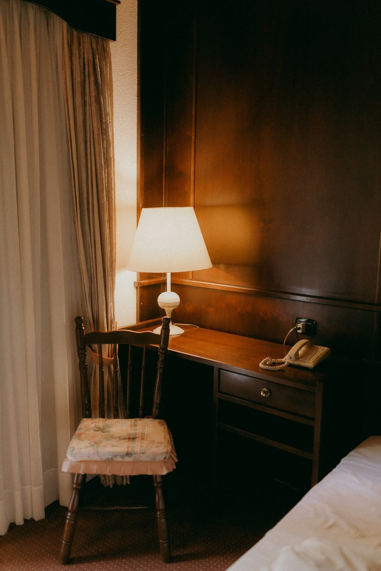 A writing desk under a warm lamp