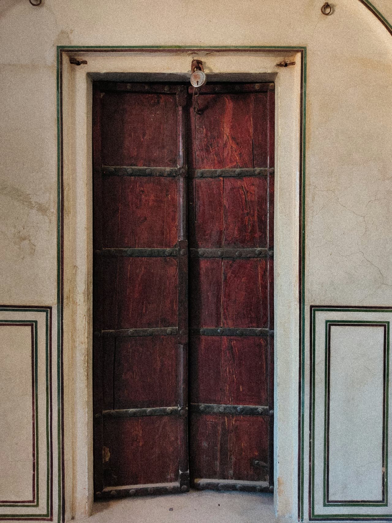 An old carved timber door in a white wall
